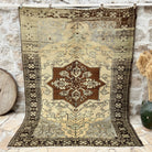 Brown 7' x 9' vintage geometric rug with medallion design, handmade in Turkey – Pollard.