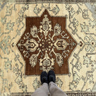 1970s brown vintage Turkish geometric rug with medallion design, hand-knotted weave and low pile.