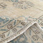 1970s blue vintage Turkish geometric rug with medallion design, hand-knotted weave and low pile.