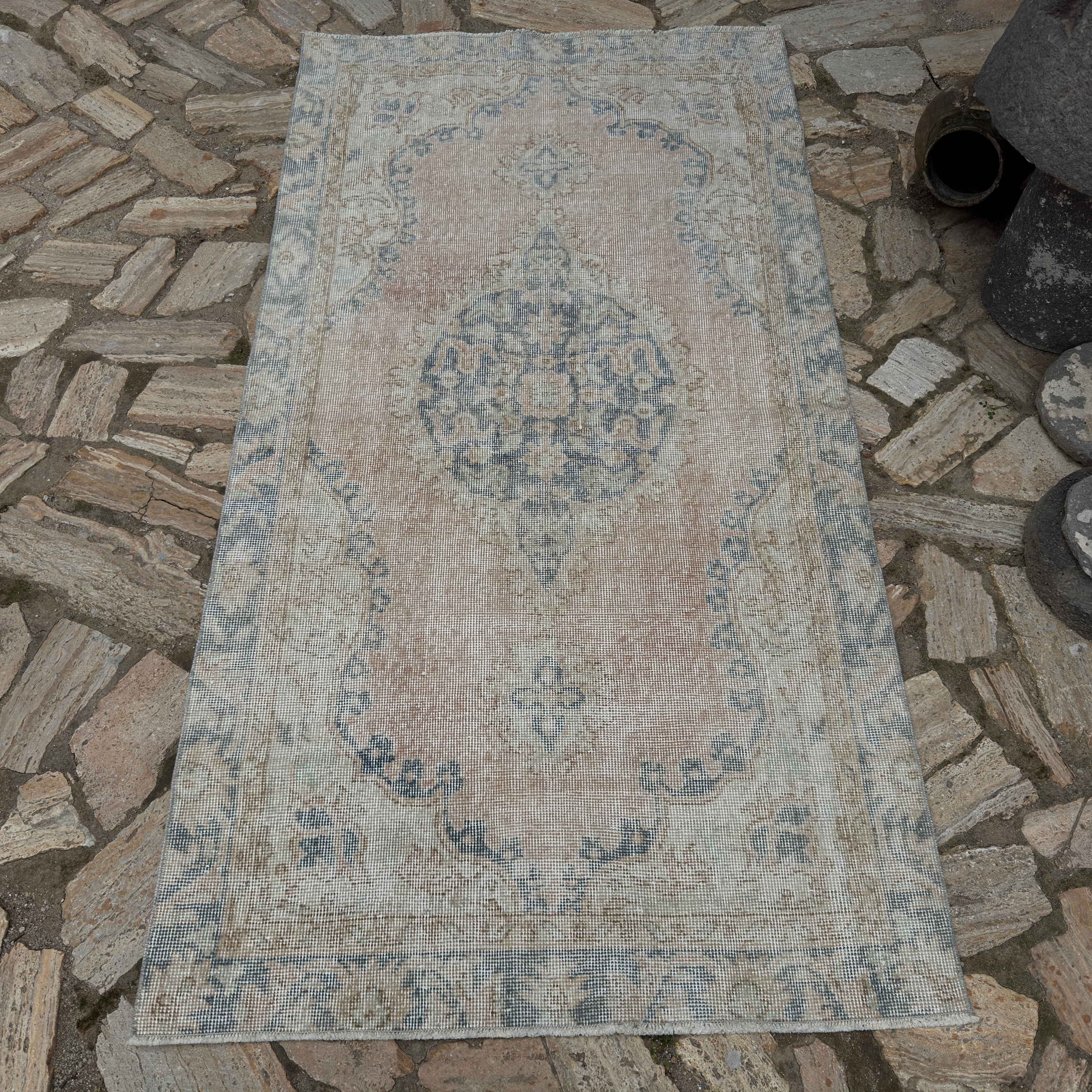 Pale Pink 3' x 6' vintage Turkish isparta rug in wool and cotton, shown on the floor.