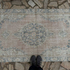 1970s pale pink vintage Turkish isparta rug with medallion design, hand-knotted weave and low pile.