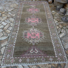 Pale Pink 5' x 11' vintage Turkish kars area rug in wool and cotton, shown on the floor.