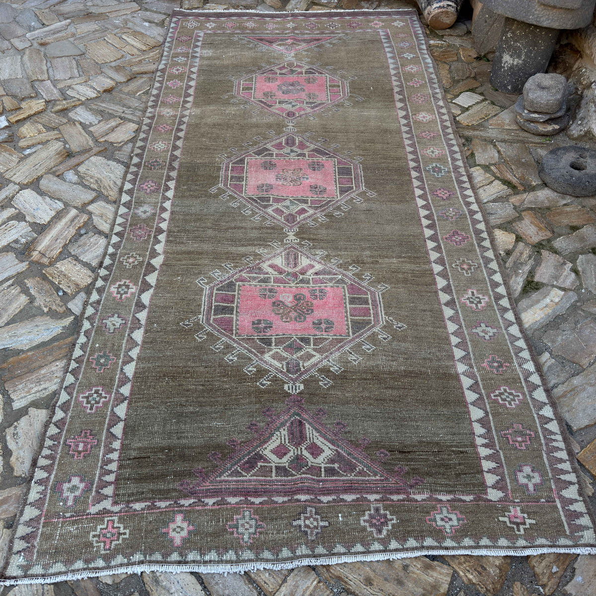 Pale Pink 5' x 11' vintage Turkish kars area rug in wool and cotton, shown on the floor.