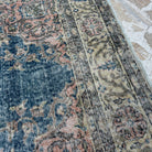 Close-up of the blue vintage Turkish kayseri rug showing traditional details, hand-knotted weave, wool and cotton and low pile.