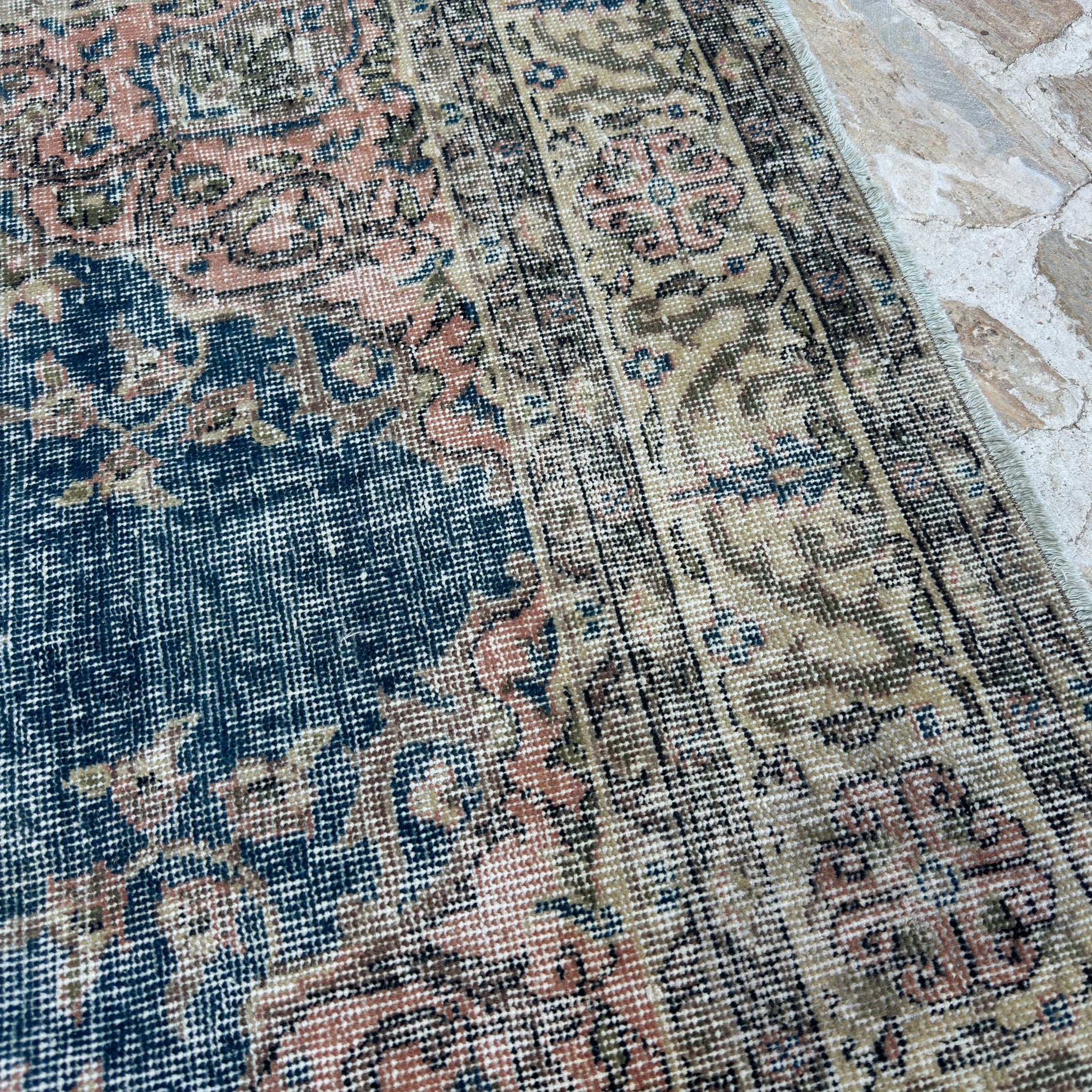Close-up of the blue vintage Turkish kayseri rug showing traditional details, hand-knotted weave, wool and cotton and low pile.