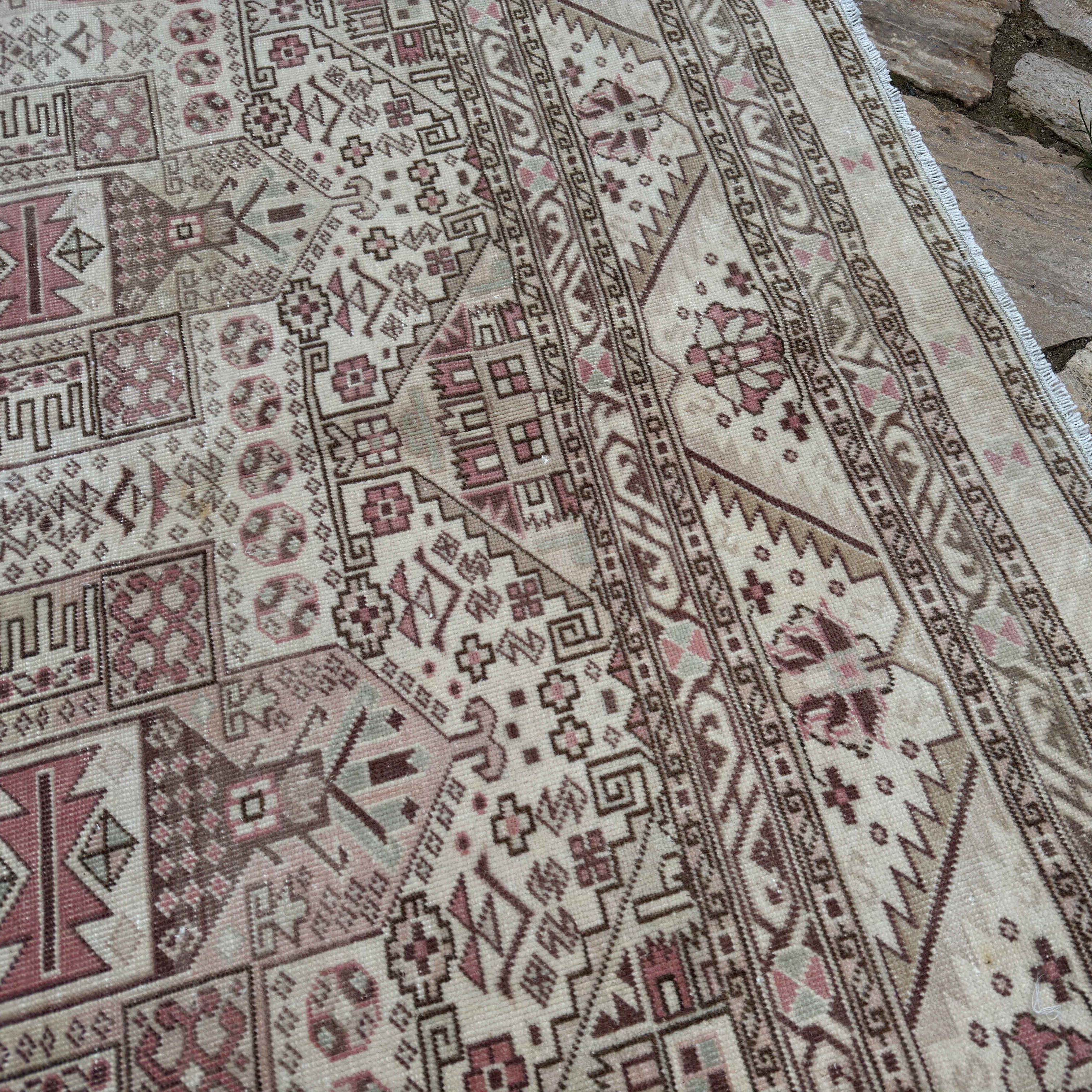 Close-up of the pale beige vintage Turkish kayseri rug showing neutral details, hand-knotted weave, wool and cotton and low pile.