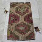 Pink 2' x 3' vintage Turkish kilim rug in wool and cotton, shown on the floor.