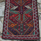 Red 2' x 3' vintage Turkish kilim rug in wool and cotton, shown on the floor.