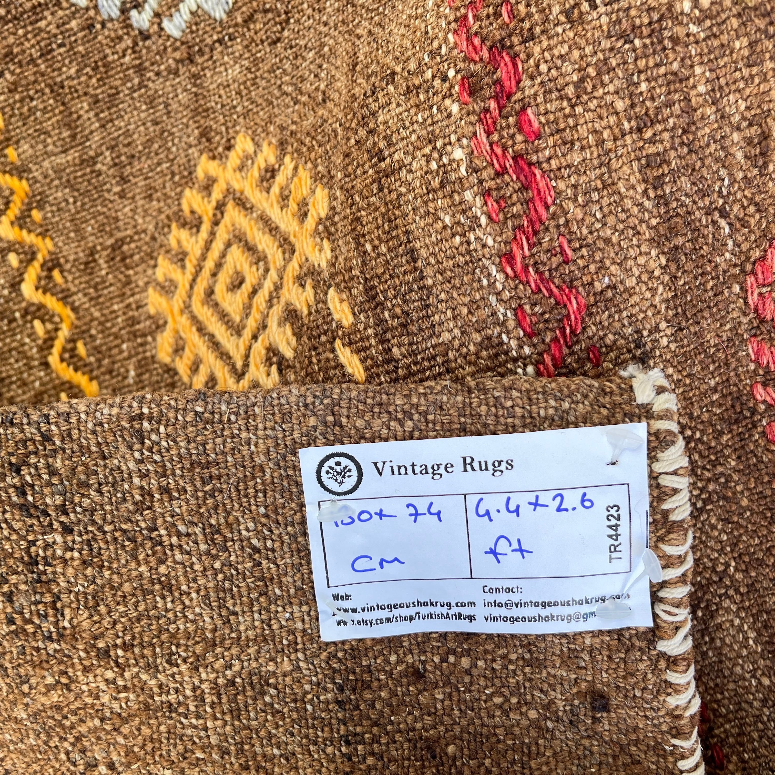 Close-up of the brown vintage Turkish kilim rug showing traditional details, flatweave construction, wool and cotton and low pile.