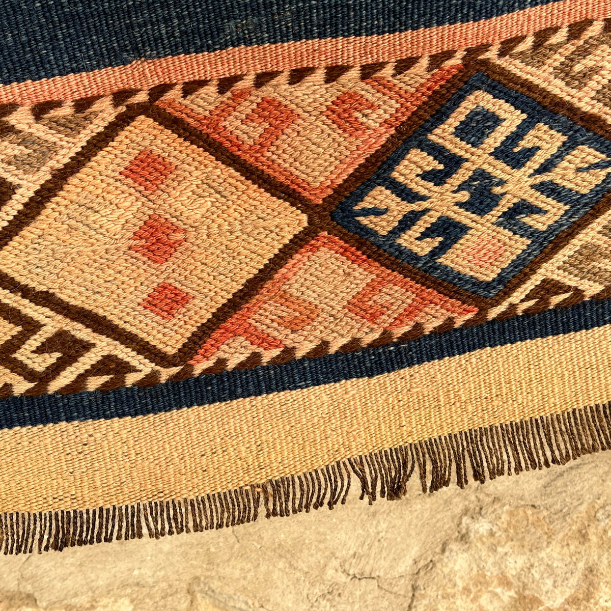 Pink 2' x 4' vintage Turkish kilim rug in wool and cotton, shown on the floor.