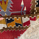 Close-up of the red vintage Turkish kilim rug showing traditional details, flatweave construction, wool and cotton and low pile.