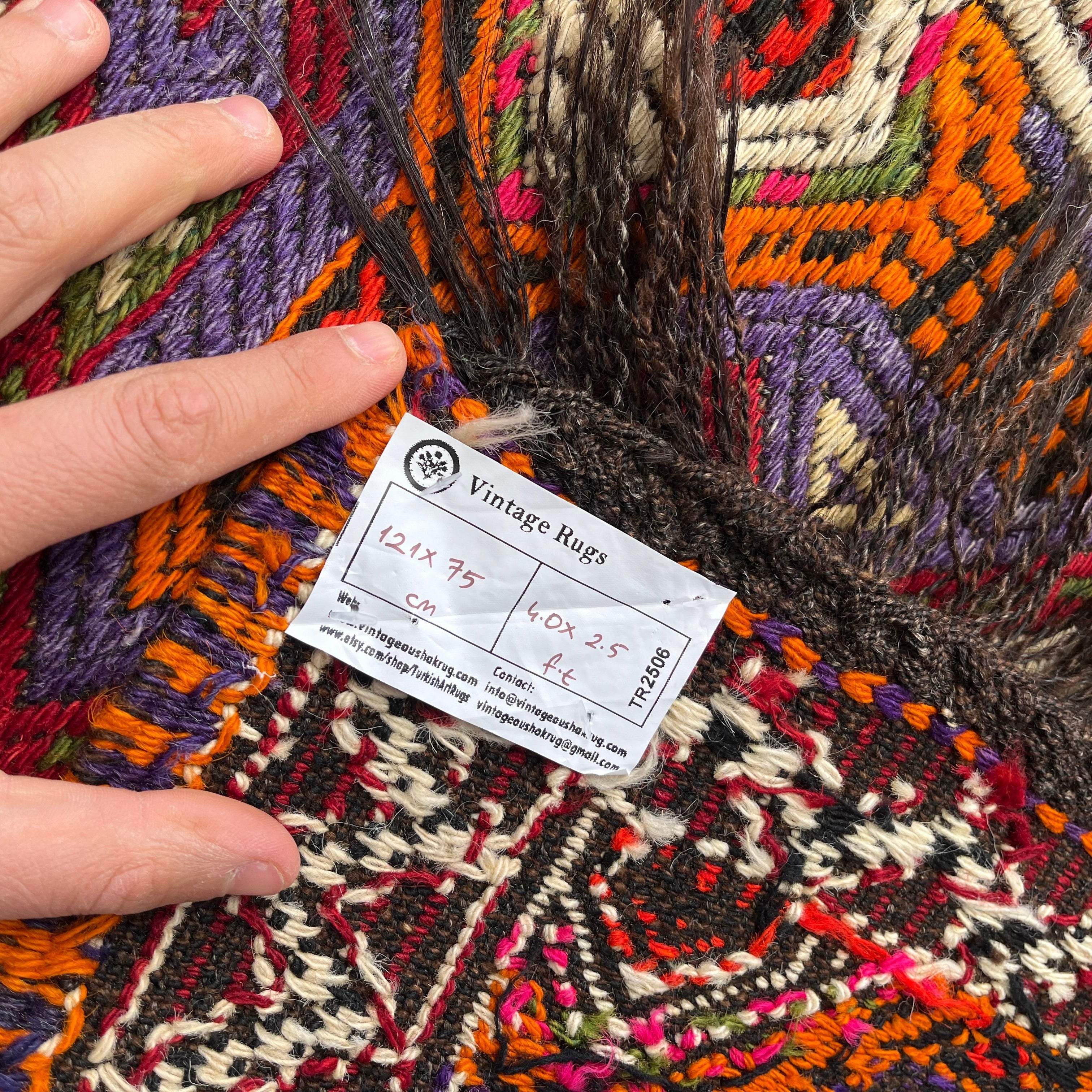 Red 2' x 4' vintage Turkish kilim rug in wool and cotton, shown on the floor.