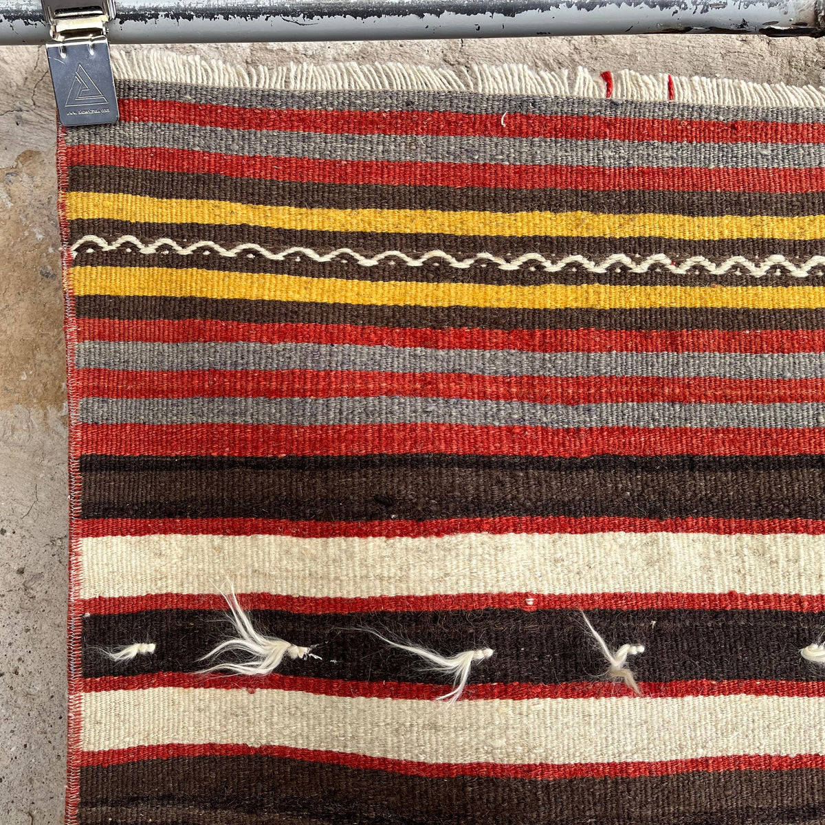 Red 2' x 4' vintage Turkish kilim rug in wool and cotton, shown on the floor.