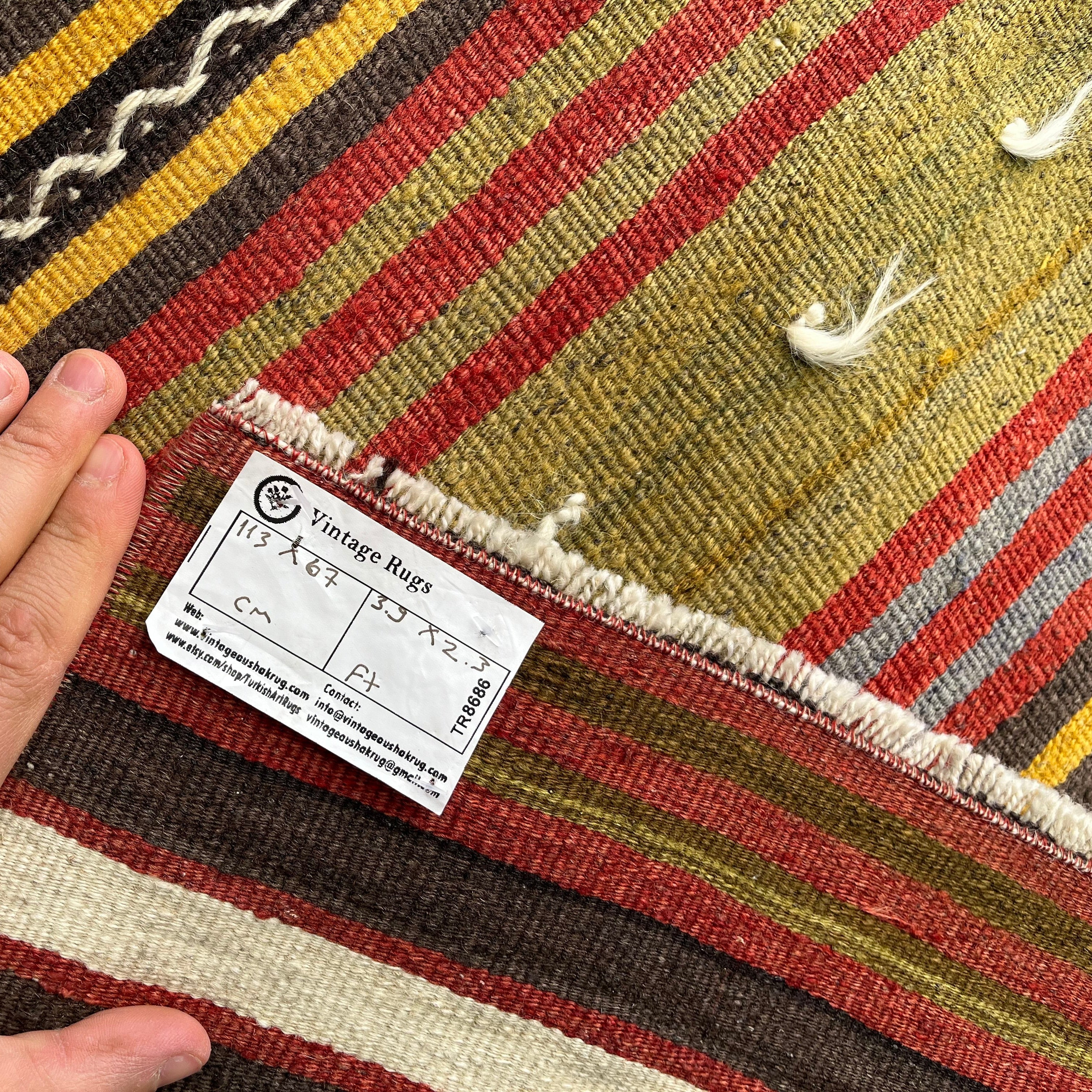 1970s red vintage Turkish kilim rug with striped design, flatweave construction and low pile.