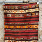 Red 2' x 6' vintage Turkish kilim rug in wool and cotton, shown on the floor.