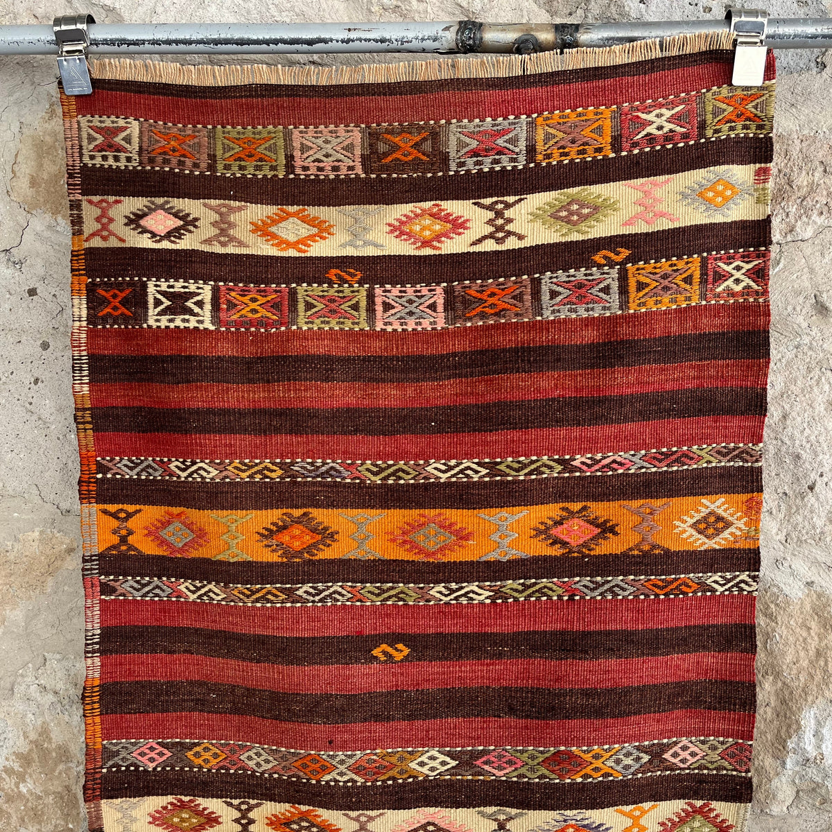 Red 2' x 6' vintage Turkish kilim rug in wool and cotton, shown on the floor.