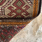 Close-up of the brown vintage Turkish kilim rug showing traditional details, flatweave construction, wool and cotton and low pile.