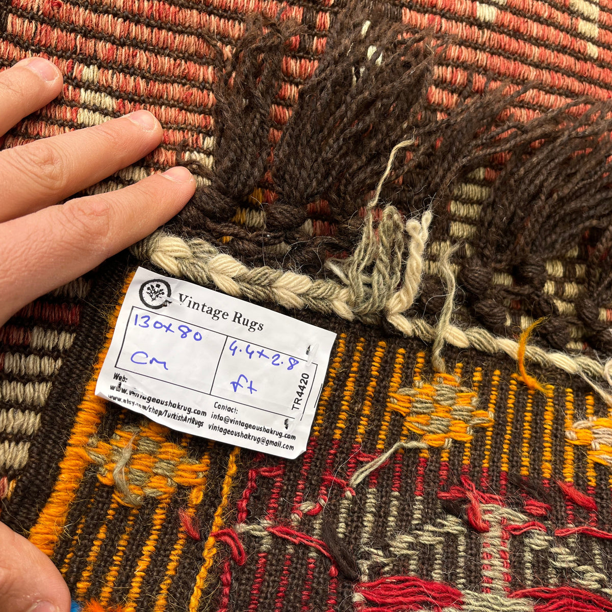 Close-up of the red vintage Turkish kilim rug showing traditional details, flatweave construction, wool and cotton and low pile.