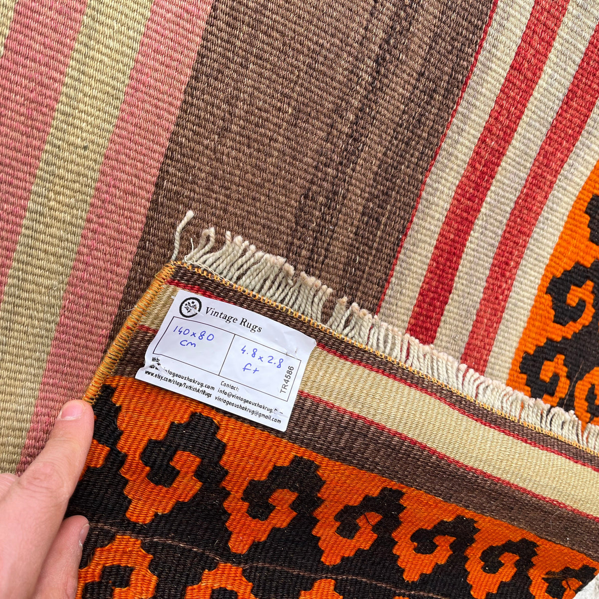 Close-up of the yellow vintage Turkish kilim rug showing striped details, flatweave construction, wool and cotton and low pile.