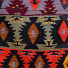 Close-up of the red vintage Turkish kilim rug showing traditional details, flatweave construction, wool and cotton and low pile.