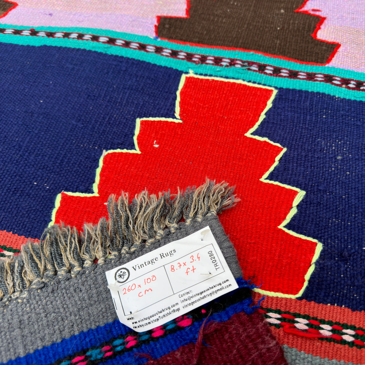 Close-up of the blue vintage Turkish kilim rug showing geometric details, flatweave construction, wool and cotton and low pile.