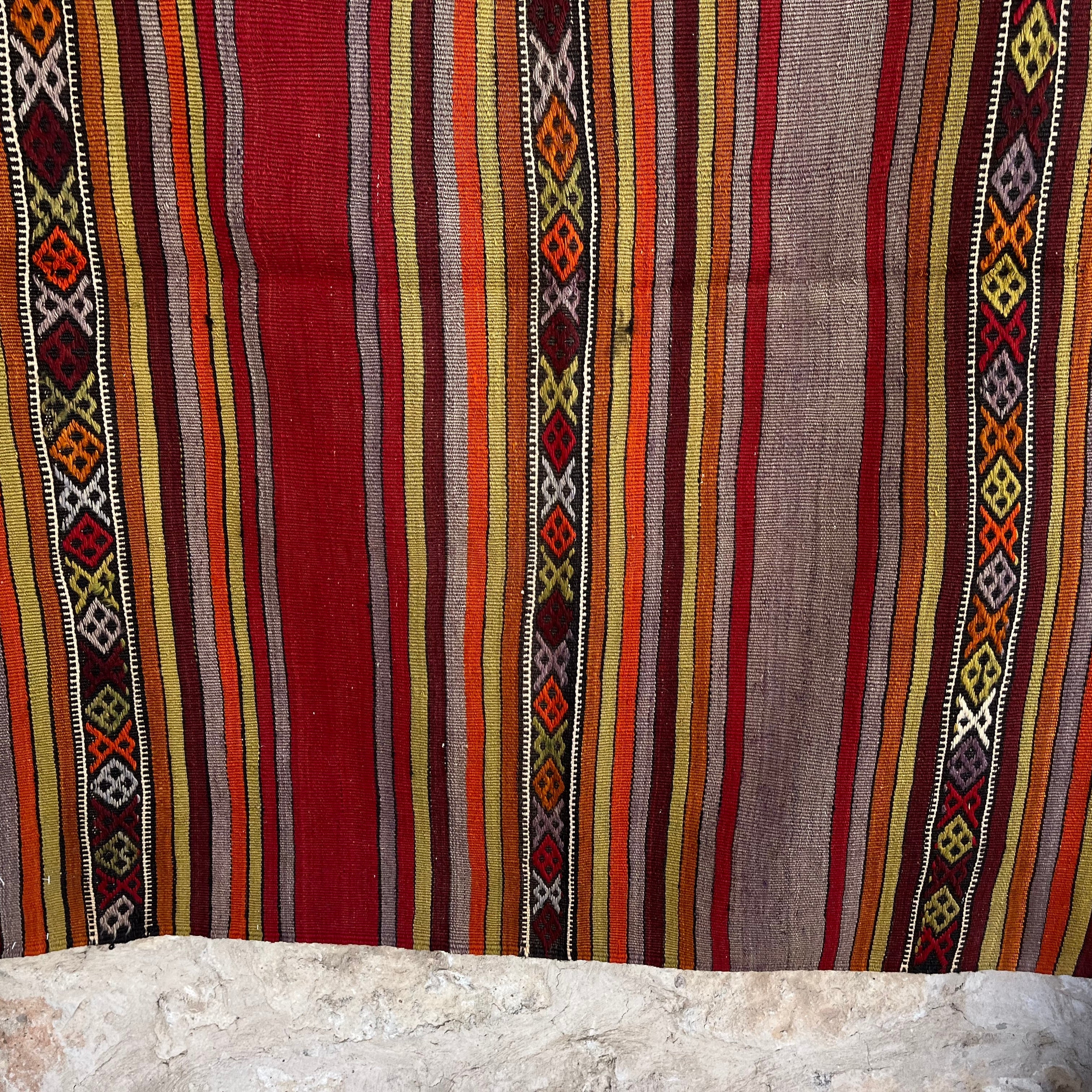Red 4' x 4' vintage Turkish kilim rug in wool and cotton, shown on the floor.