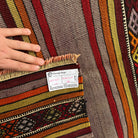 1970s red vintage Turkish kilim rug with striped design, flatweave construction and low pile.