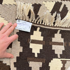 Close-up of the black vintage Turkish kilim rug showing traditional details, flatweave construction, wool and cotton and low pile.