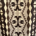 Black 4' x 6' vintage Turkish kilim rug in wool and cotton, shown on the floor.
