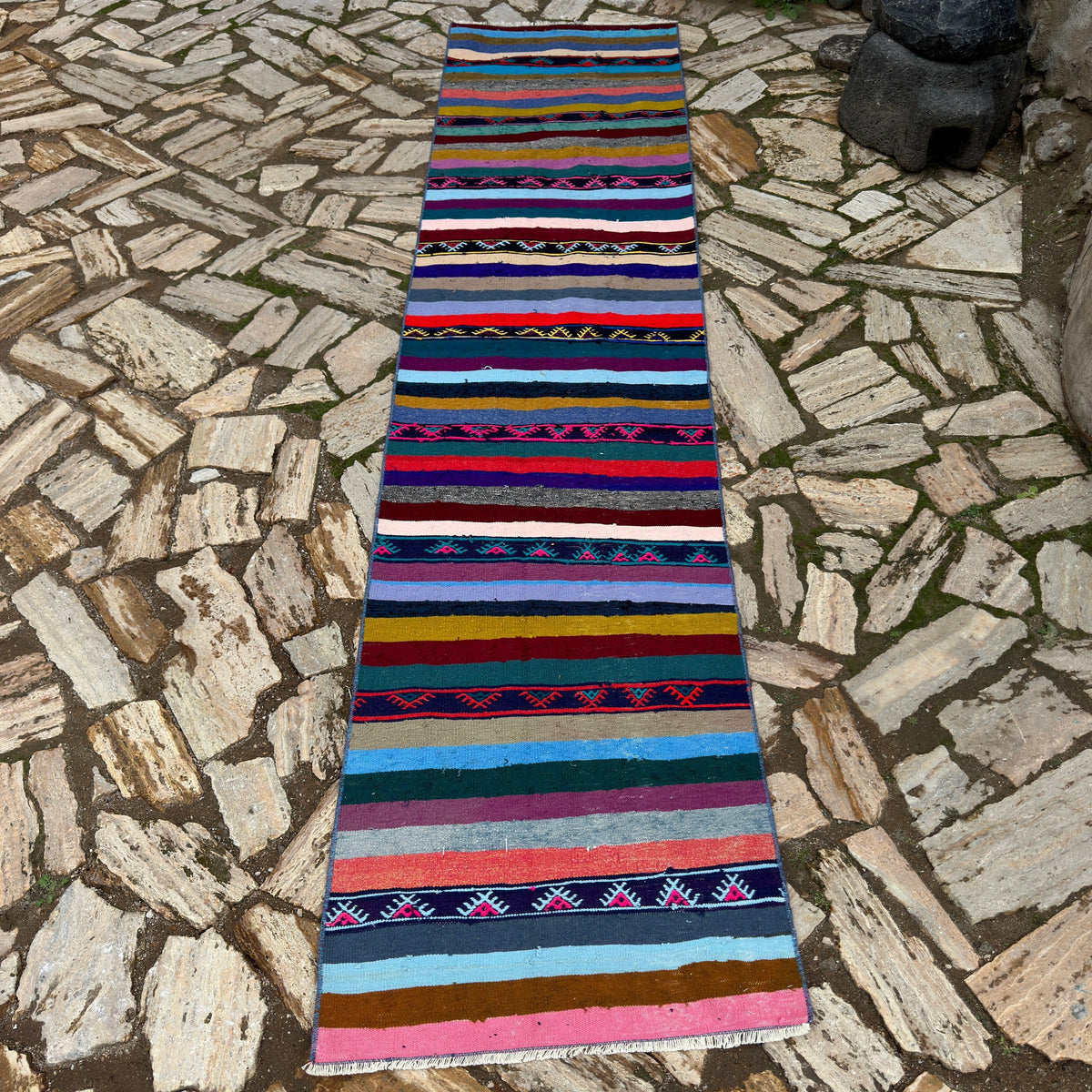 Blue 2' x 10' vintage Turkish kilim runner rug in wool and cotton, shown on the floor.