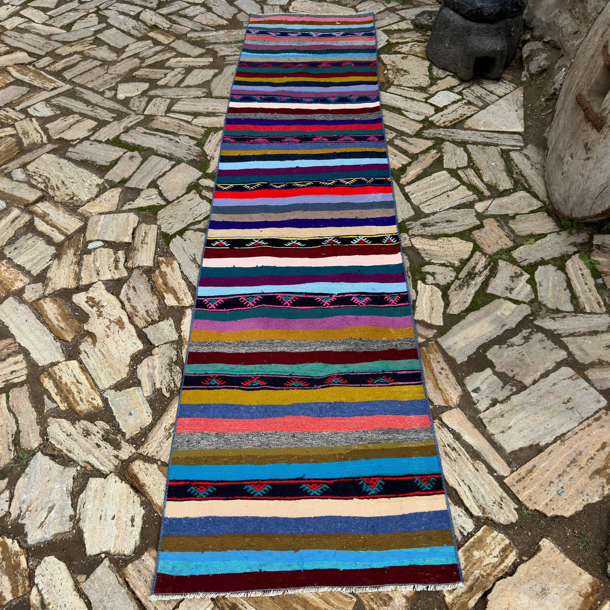 Pink 2' x 10' vintage Turkish kilim runner rug in wool and cotton, shown on the floor.
