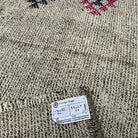 Close-up of the gray vintage Turkish kilim runner rug showing traditional details, hand-knotted weave, wool and cotton and low pile.