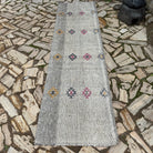 Gray 3' x 10' vintage Turkish kilim runner rug in wool and cotton, shown on the floor.