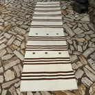Beige 3' x 11' vintage Turkish kilim runner rug in wool and cotton, shown on the floor.