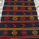 Close-up of the black vintage Turkish kilim runner rug showing traditional details, flatweave construction, wool and cotton and low pile.