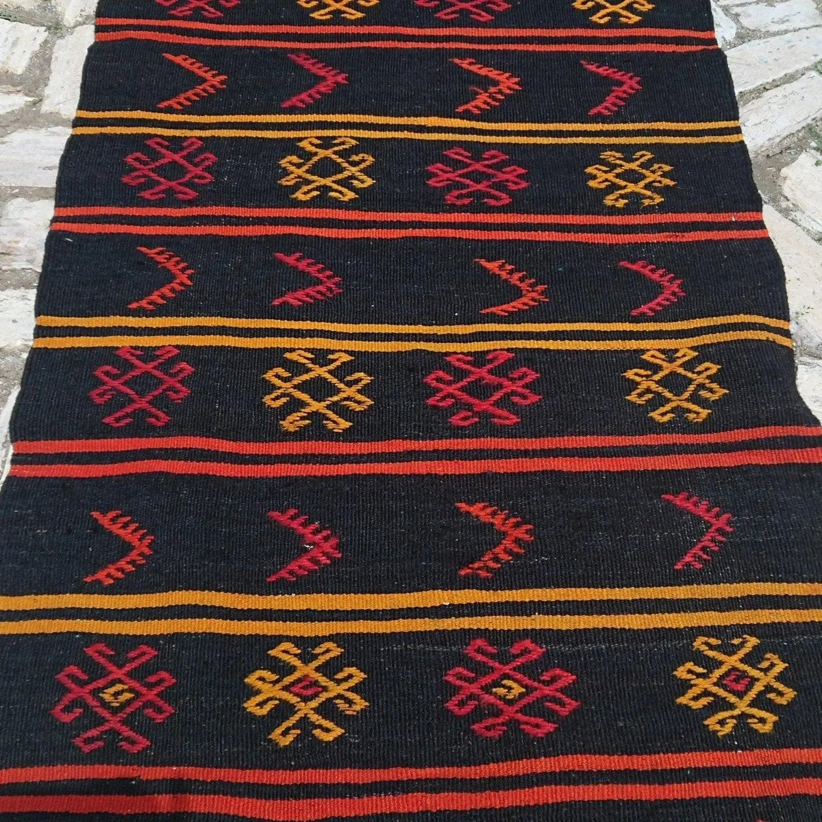 Close-up of the black vintage Turkish kilim runner rug showing traditional details, flatweave construction, wool and cotton and low pile.