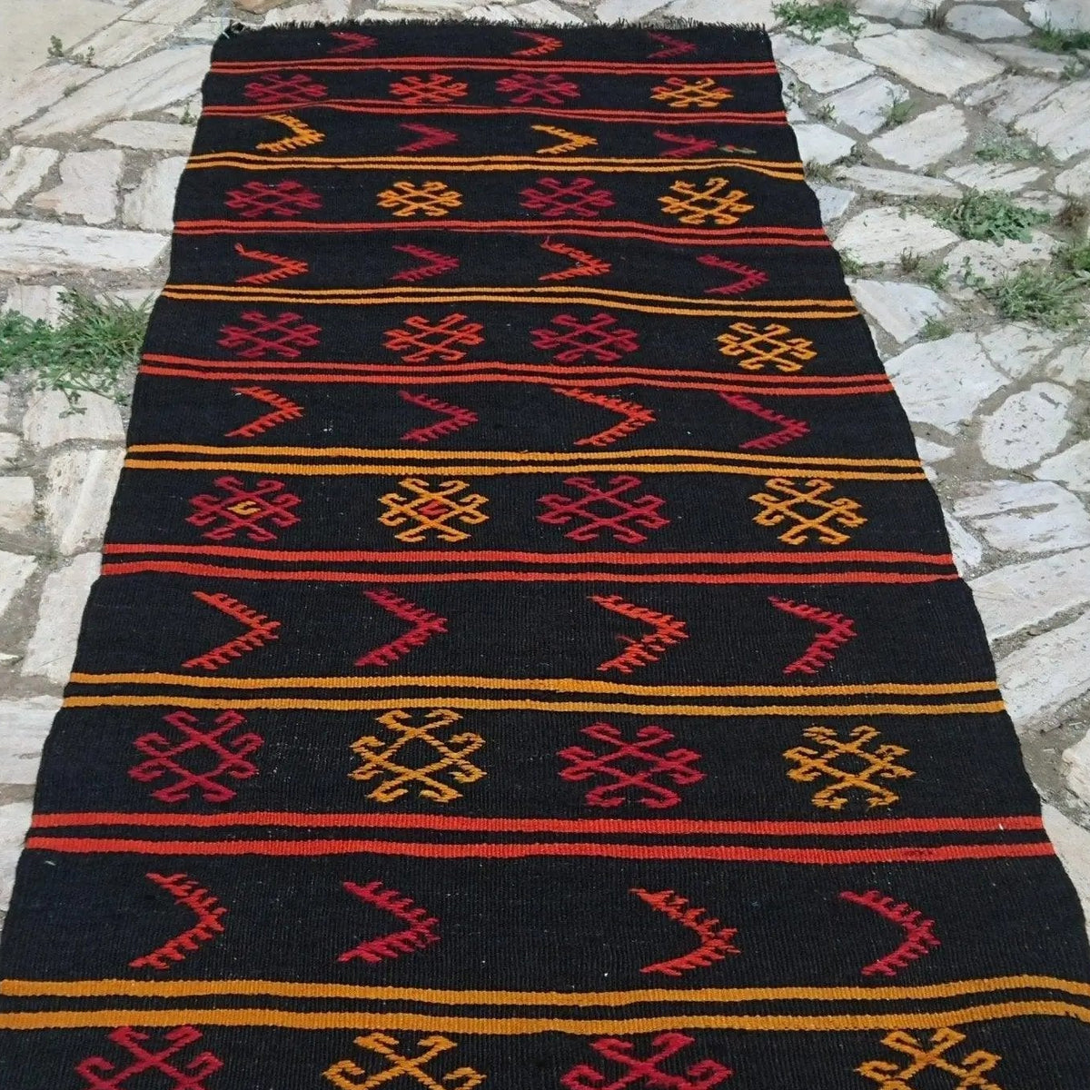 1970s black vintage Turkish kilim runner rug with traditional design, flatweave construction and low pile.