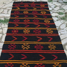 1970s black vintage Turkish kilim runner rug with traditional design, flatweave construction and low pile.