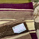 Close-up of the green vintage Turkish kilim runner rug showing striped details, flatweave construction, wool and cotton and low pile.