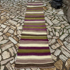 Green 3' x 11' vintage Turkish kilim runner rug in wool and cotton, shown on the floor.