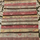1970s red vintage Turkish kilim runner rug with striped design, flatweave construction and low pile.