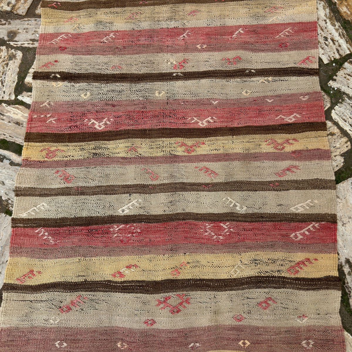 1970s red vintage Turkish kilim runner rug with striped design, flatweave construction and low pile.