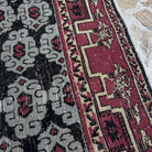 Close-up of the blue vintage Turkish konya rug showing geometric details, hand-knotted weave, wool and cotton and low pile.