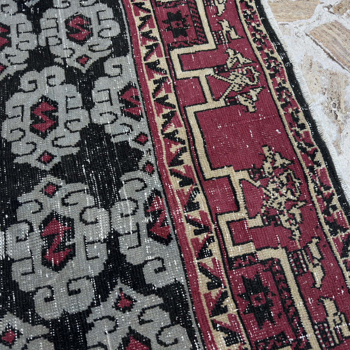 Close-up of the blue vintage Turkish konya rug showing geometric details, hand-knotted weave, wool and cotton and low pile.