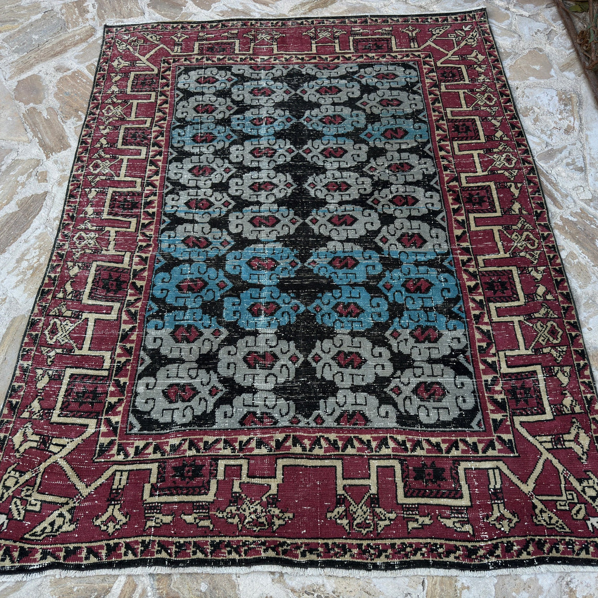 Blue 5' x 7' vintage Turkish konya rug in wool and cotton, shown on the floor.