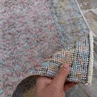 Close-up of the pink vintage Turkish large floral rug showing floral details, hand-knotted weave, wool and cotton and low pile.