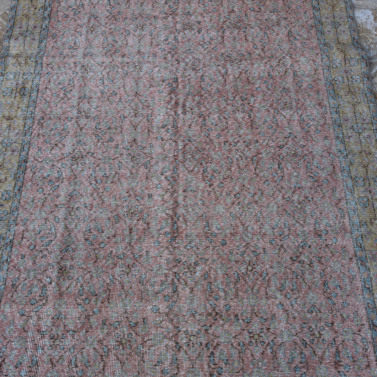 1970s pink vintage Turkish large floral rug with floral design, hand-knotted weave and low pile.