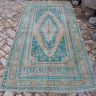 Pale Green 5' x 10' vintage Turkish large rug in wool and cotton, shown on the floor.