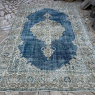 Blue 7' x 10' vintage Turkish large rug in wool and cotton, shown on the floor.