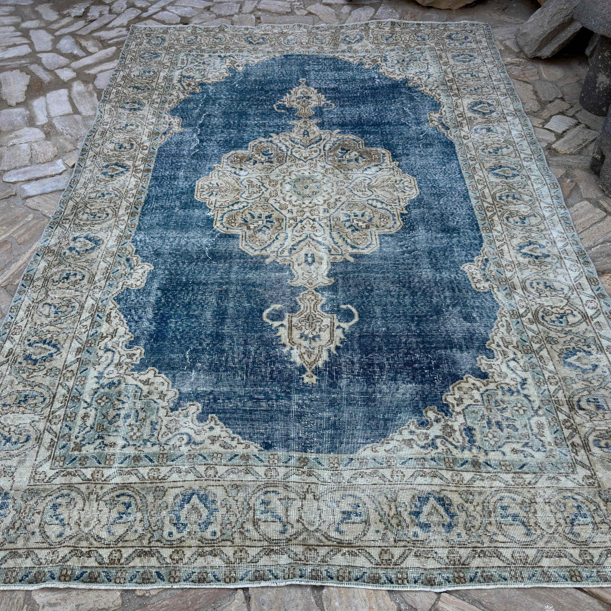 Blue 7' x 10' vintage Turkish large rug in wool and cotton, shown on the floor.